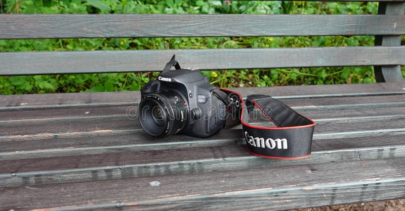 Itterbeck, Germany - Sept. 13 2021 A Canon EOS 700D SLR camera with EF-S mount from 2013 is lying on a wooden green bench.  This camera is known as the Kiss X7i in Japan and as the Rebel T5i in  America. It is a digital single-lens reflex camera. Itterbeck, Germany - Sept. 13 2021 A Canon EOS 700D SLR camera with EF-S mount from 2013 is lying on a wooden green bench.  This camera is known as the Kiss X7i in Japan and as the Rebel T5i in  America. It is a digital single-lens reflex camera.