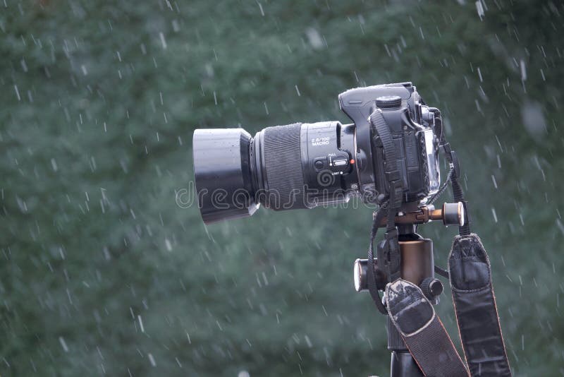 The close-up of DSLR camera in snow. The close-up of DSLR camera in snow