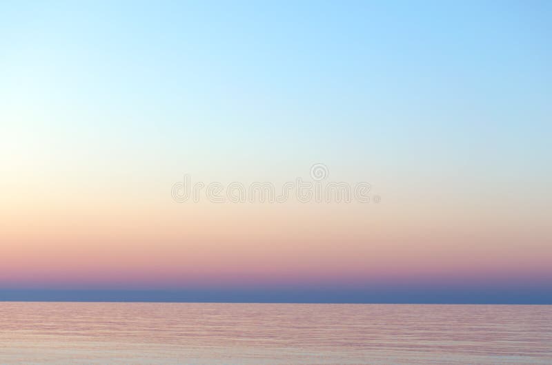 Clear sunset sky. Gradient background in pastel colors. Sunset over the sea. Beach dawn. Light nature exposure. Clear sunset sky. Gradient background in pastel colors. Sunset over the sea. Beach dawn. Light nature exposure