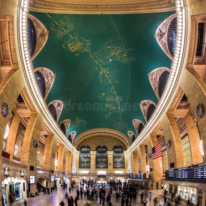 Main Concourse of the Grand Central Terminal railroad station in New York City. The Grand Central Terminal is an iconic landmark, famous for it's spherical ceiling depicting the astronomical sky with stars and constellations. Tourists and commuters are in motion in the hall. Main Concourse of the Grand Central Terminal railroad station in New York City. The Grand Central Terminal is an iconic landmark, famous for it's spherical ceiling depicting the astronomical sky with stars and constellations. Tourists and commuters are in motion in the hall.