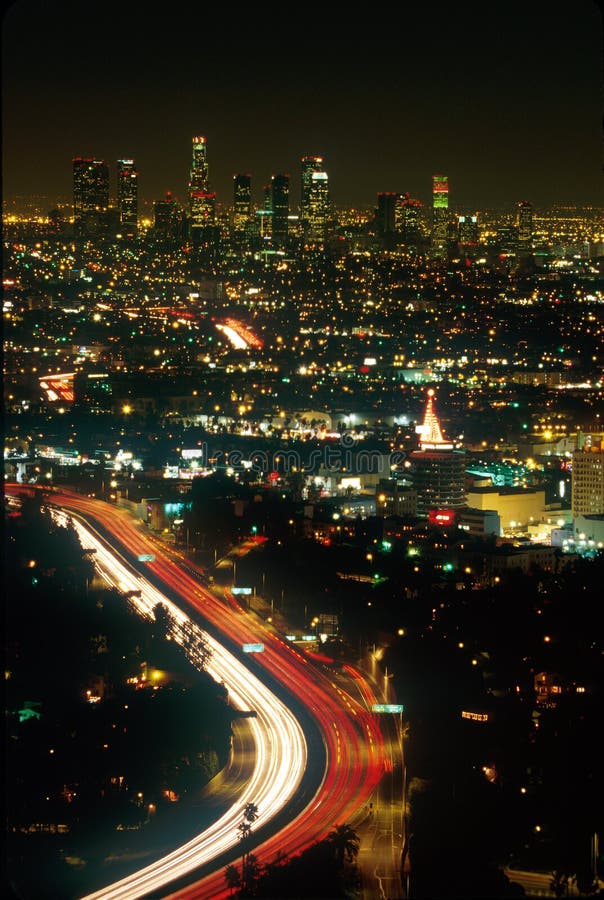 Red and white lights of traffic flowing through the bright lights of Los Angeles at night, seen form above. Red and white lights of traffic flowing through the bright lights of Los Angeles at night, seen form above.