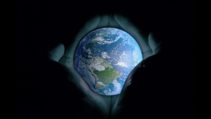 3d animation: The planet earth with a blue glow revolves around its axis on a black background. Gradually appears men`s hands