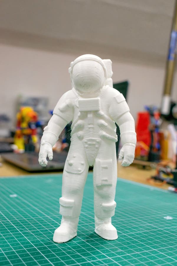 3D printed astronaut, cosmonaut, robot on the background of devices and laptop. Spaceman model printed on automatic three dimensional 3d printer, printing, additive, manufacturing, ai, artificial, intelligence, automation, white, children, computer, cords, creation, design, digital, education, electronics, engineering, equipment, future, industrial, industry, innovation, machine, learning, mechanics, modern, plastic, process, production, robotics, science, study, technology, tool, toy. 3D printed astronaut, cosmonaut, robot on the background of devices and laptop. Spaceman model printed on automatic three dimensional 3d printer, printing, additive, manufacturing, ai, artificial, intelligence, automation, white, children, computer, cords, creation, design, digital, education, electronics, engineering, equipment, future, industrial, industry, innovation, machine, learning, mechanics, modern, plastic, process, production, robotics, science, study, technology, tool, toy