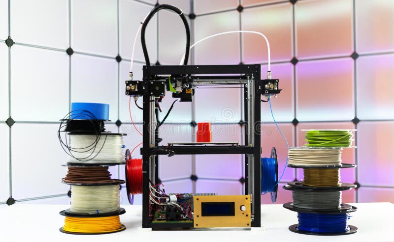 3d printer and plastic filament on color background. 3d printer and plastic filament on color background.