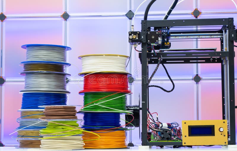 3D Printer and spools of plastic filaments. 3D Printer and spools of plastic filaments.