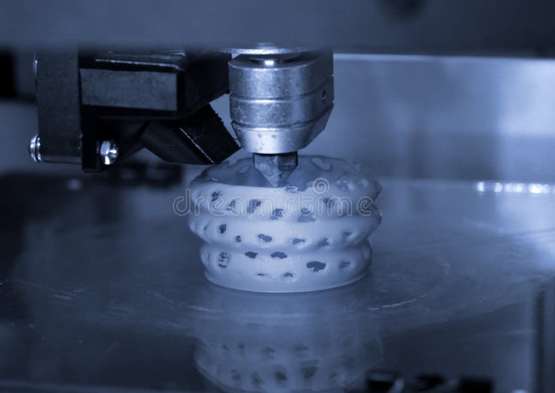 3D printer prints bkue gray form figure close stock image