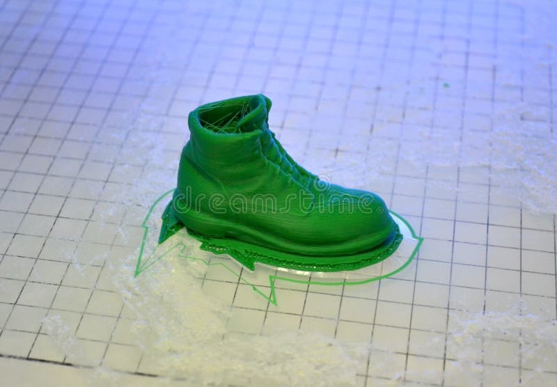 3D printer prints the form of molten plastic green. stock photo