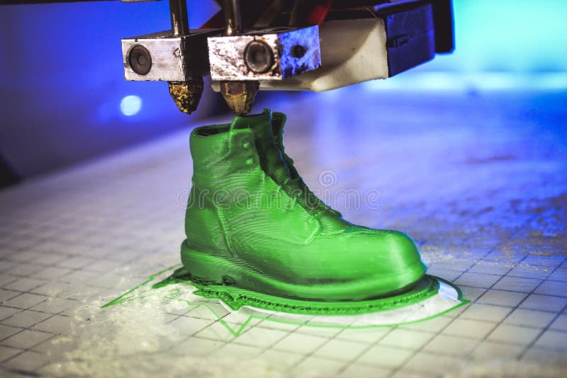 3D printer prints the form of molten plastic green close-up.