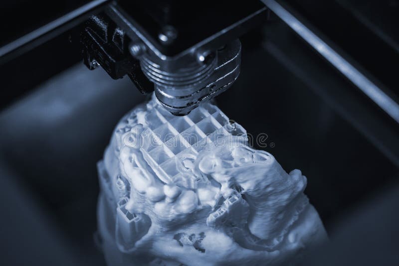 3D printer prints the form of molten plastic white. stock photos