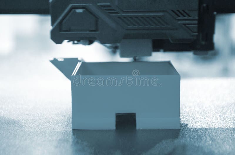 3D printer prints object. The process of printing model on 3D printer Blue color royalty free stock photo