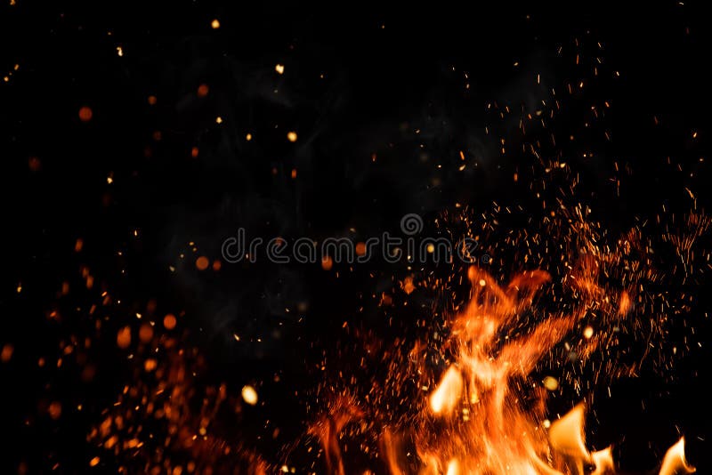 Detail of fire sparks isolated on black background. Abstract flaming background. Detail of fire sparks isolated on black background. Abstract flaming background