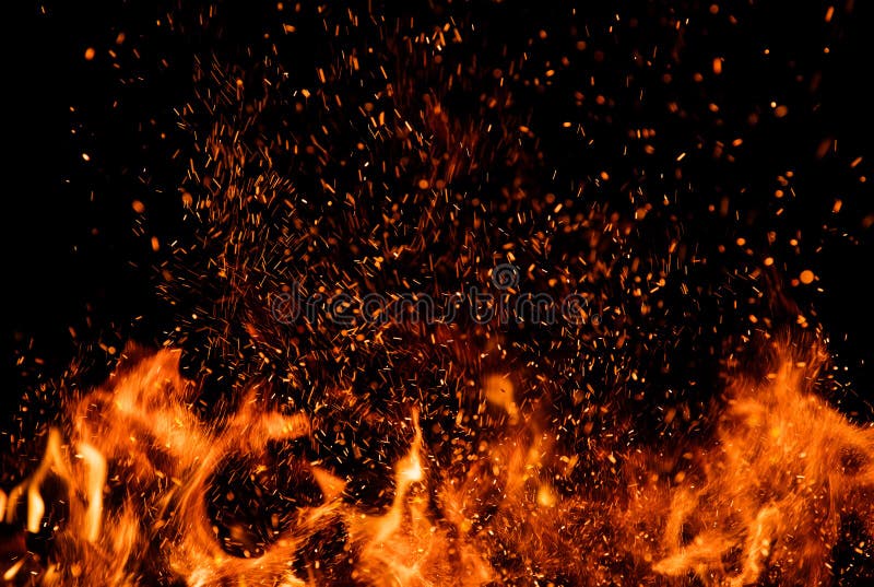 Detail of fire sparks isolated on black background. Abstract flaming background. Detail of fire sparks isolated on black background. Abstract flaming background