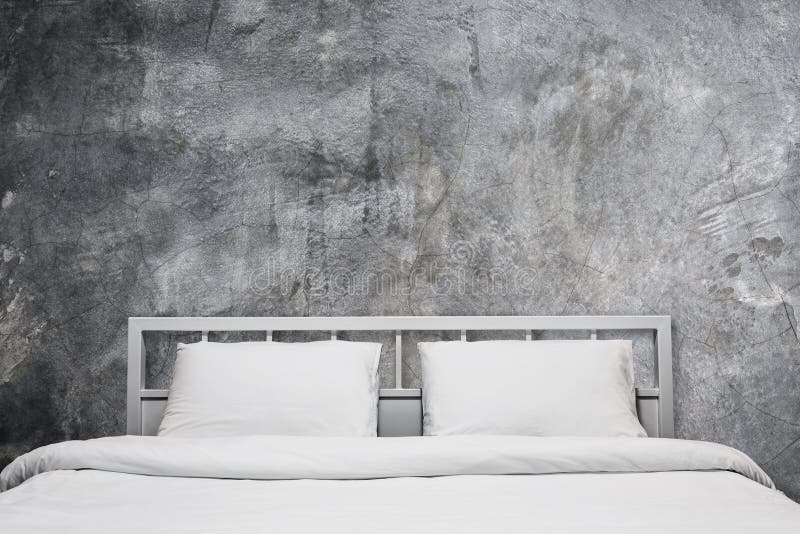 Loft interior of white bedroom with gray cement wall background. Loft interior of white bedroom with gray cement wall background