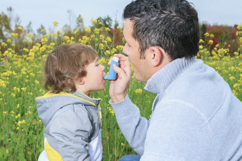 Dad give inhaler for respiratory system issues stock image