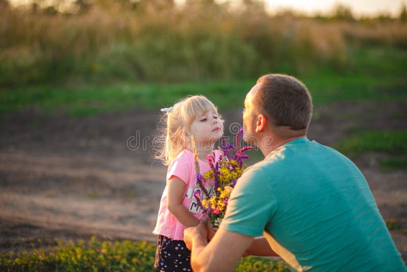 Dad Gives His Daughter Flowers at Sunset Stock Photo Image of