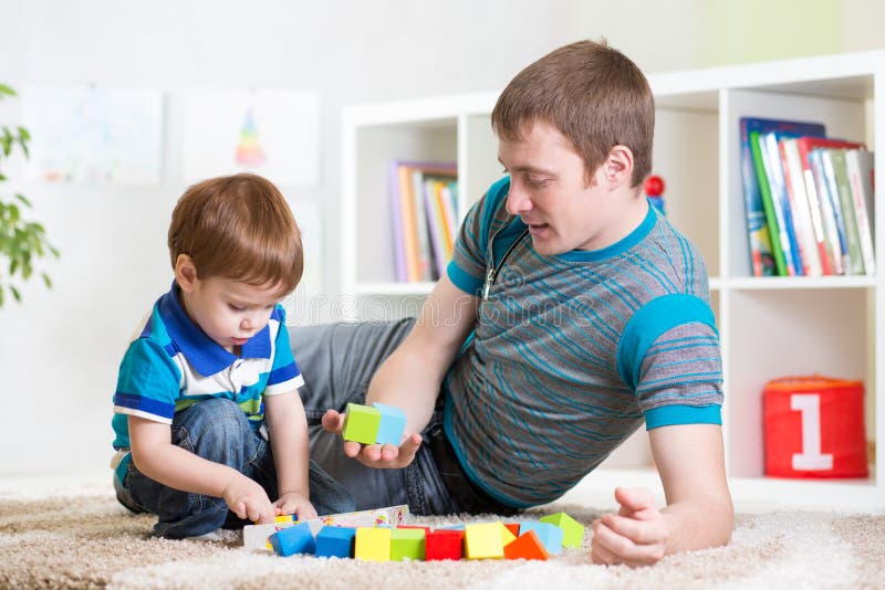 Dad with his son play together stock photo Dad with his son play together stock photo