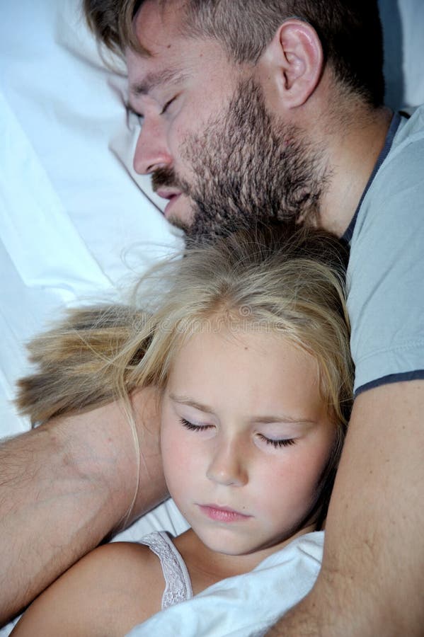 Dad and Little Girl Sleeping Together on Bed Stock Image - I