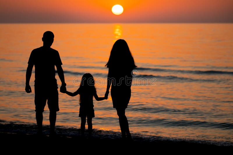 Dad, Mom And Daughter Are Watching The Sunrise photo