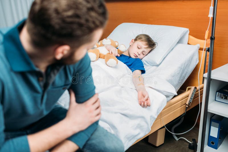 Dad Sitting Near Sick Son in Hospital Bed Stock Photo Image of
