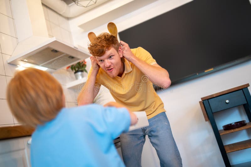 Dad and son having fun together and looking excited royalty free stock images