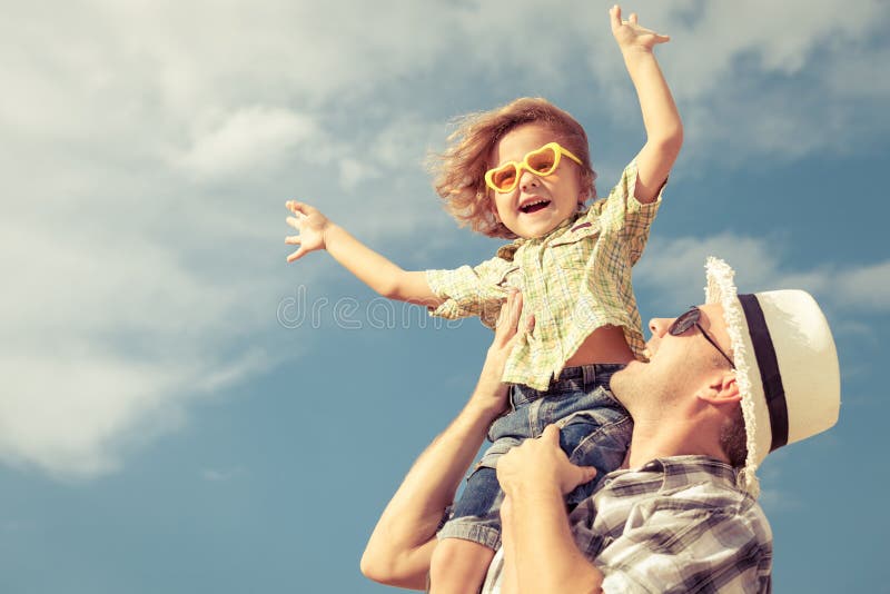 Dad and son playing near a house royalty free stock photo