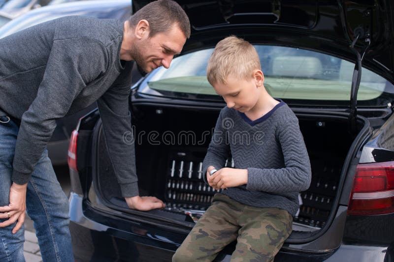 Dad Teaches His Cute Son To Use a Car Repair Tool Stoc picture picture