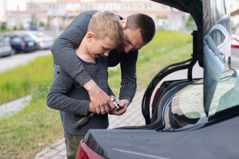 Dad Teaches His Cute Son To Use a Car Repair Tool Stoc