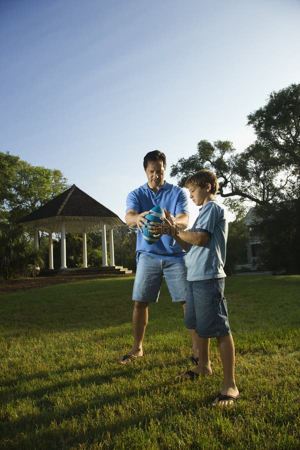 Dad teaching son football. stock photo. Image of caucasian - 2046168