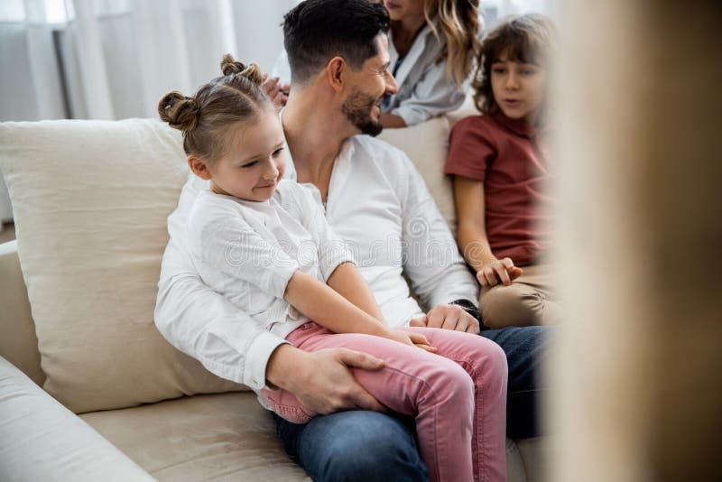 Daddy with Daughter Sitting on His Lap Stock Ph image