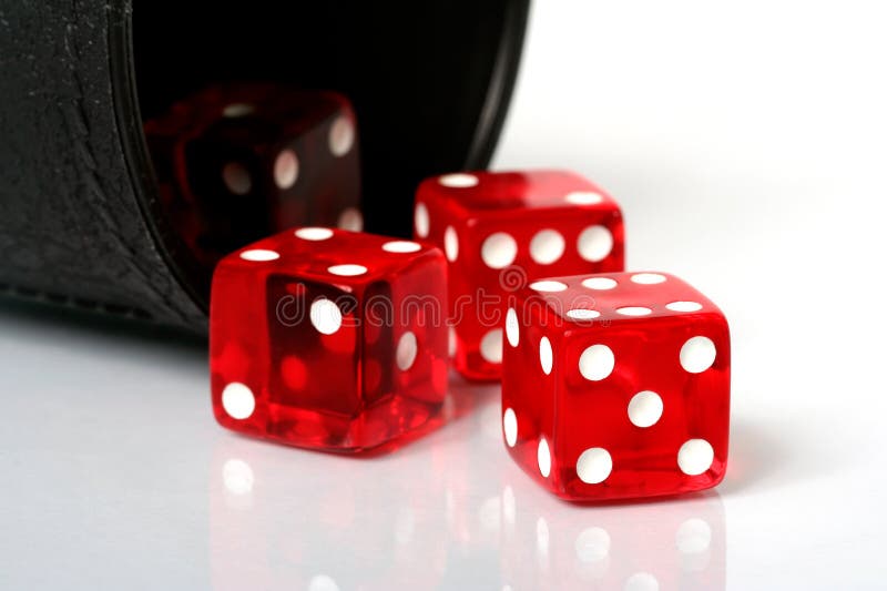 Red dice thrown from dice cup onto white background. Red dice thrown from dice cup onto white background