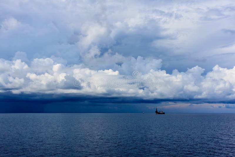 Daek blue sea color and storm raining cloud with drilling rig b stock photos Daek blue sea color and storm raining cloud with drilling rig b stock photos