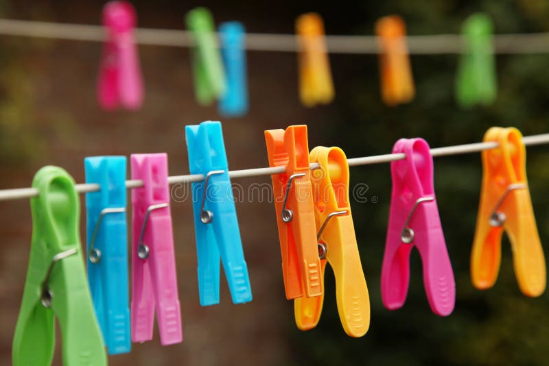 Colorful clothes pegs for hanging washed clothes on a line during laundry day. Colorful clothes pegs for hanging washed clothes on a line during laundry day