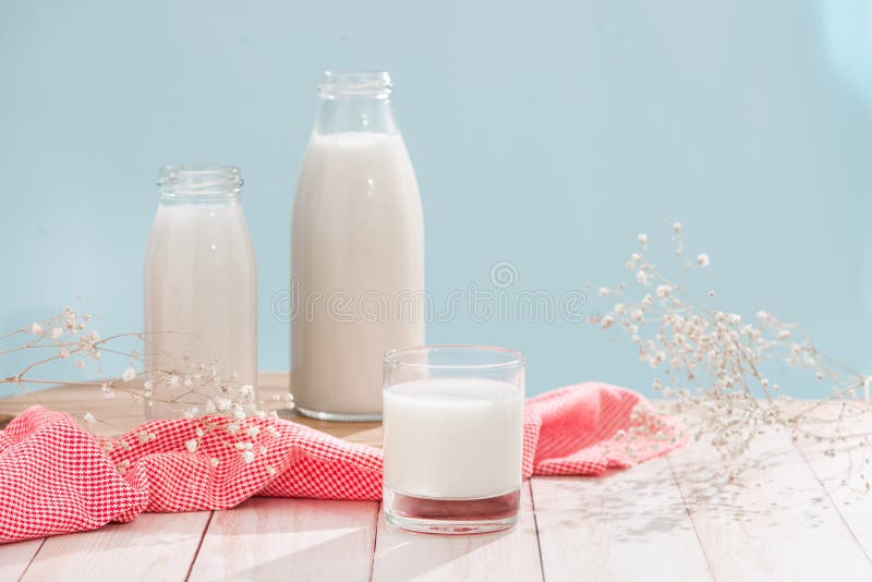 Dairy products. Bottle with milk and glass of milk on wooden tab stock photo Dairy products. Bottle with milk and glass of milk on wooden tab stock photo