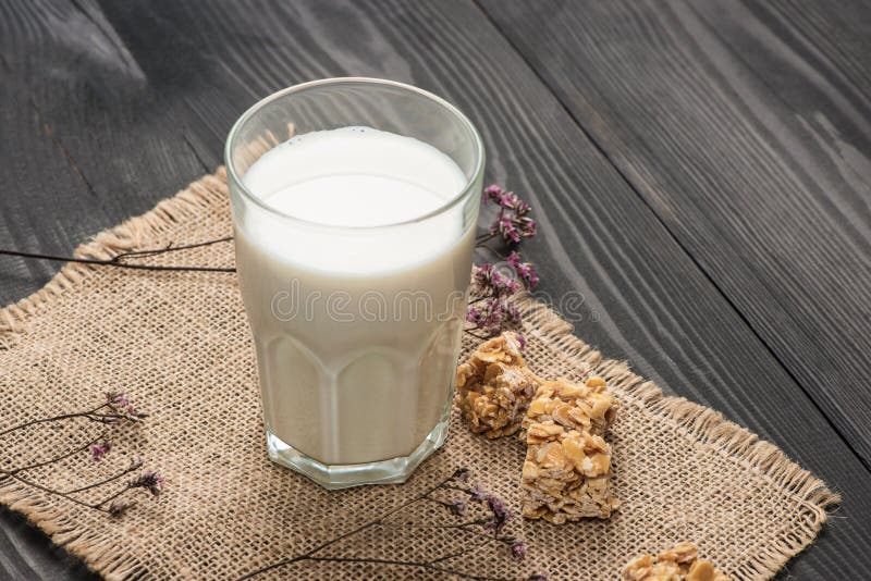 Dairy products. A glass of milk serve with almond candies on a r royalty free stock photos Dairy products. A glass of milk serve with almond candies on a r royalty free stock photos