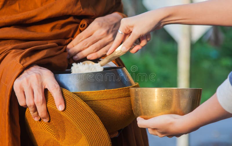 Woman give alms to a Buddhist monk on morning. Woman give alms to a Buddhist monk on morning