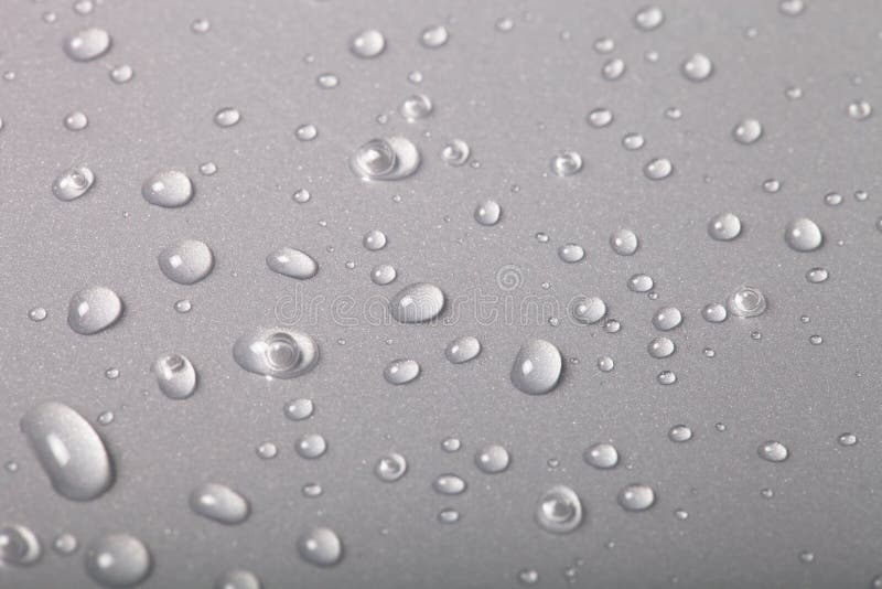 Drops of water on a color background. Gray. Shallow depth of field. Selective focus. Drops of water on a color background. Gray. Shallow depth of field. Selective focus.