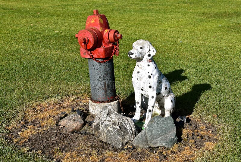 Dalmation dog from a mold is placed next to a fire hydrant
