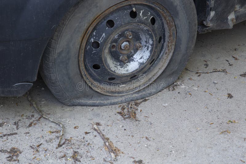 Damage To the Car Tire. a Tire Puncture.a Car with a Flat Tire Stock