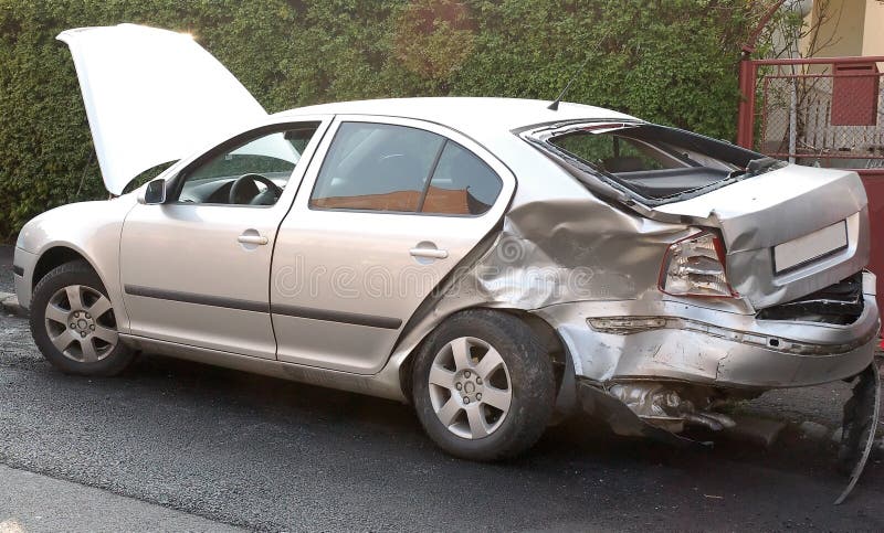 Car damaged in car crash, back of the car is damaged. car color is silver. car is placed on street. Car damaged in car crash, back of the car is damaged. car color is silver. car is placed on street.