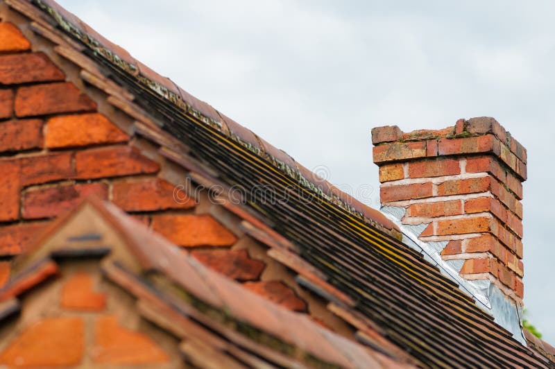 Damaged chimney needs repair old rooftop building exterior