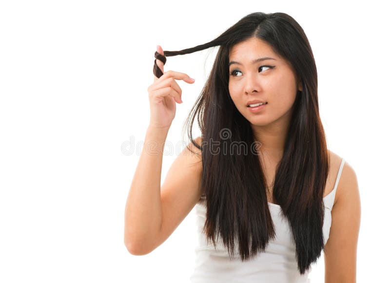 Portrait of Asian woman holding damaged dry hair and sad looking isolated on white background