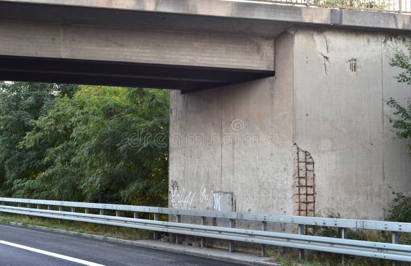 Old concrete bridge with damages over highway. Old concrete bridge with damages over highway