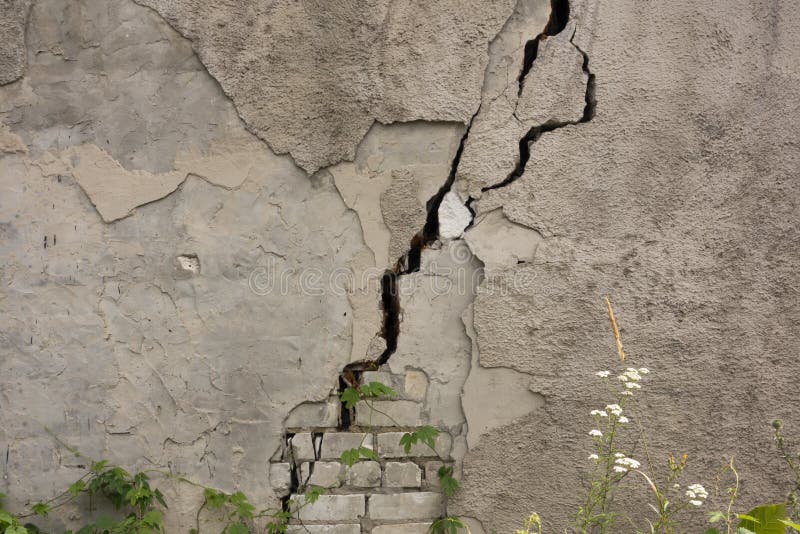 Damaged house dilapidated old building wall. Private abandoned home fall to ruin. Sunny day, horizontal orientation, nobody.