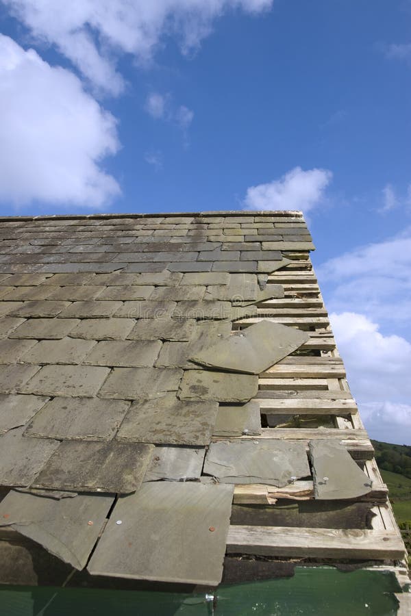 Damaged roof with broken slates