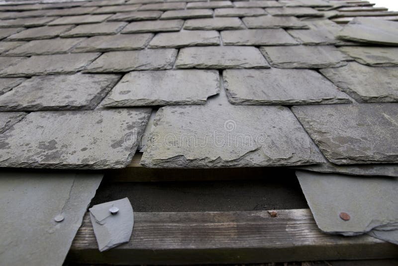 Damaged roof with missing slates royalty free stock images
