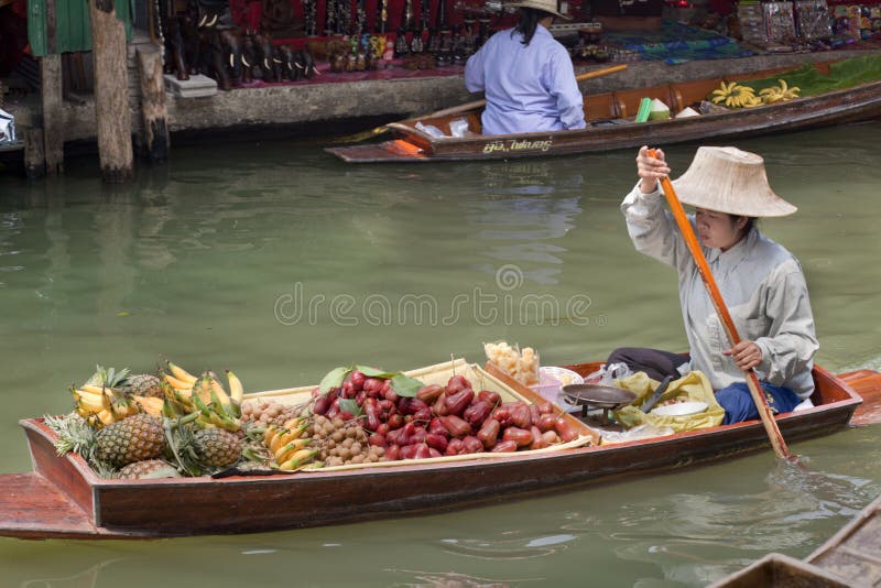 Traditional Thai culture of buying and selling of plants, fruit, fish and other handcrafted items. The Floating market is a popular tourist destination. The Famous Damnoen Saduak Floating Market southwest of Bangkok, Thailand has been used in many movies from James Bond, Man with the Golden Gun to The Hangover II. Fruit scene stock images, royalty-free photos and pictures