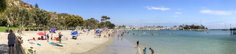 DANA COVE, CA - JULY 31, 2017: Tourists enjoy Dana Cove Beach on a sunny day. DANA COVE, CA - JULY 31, 2017: Tourists enjoy Dana Cove Beach on a sunny day