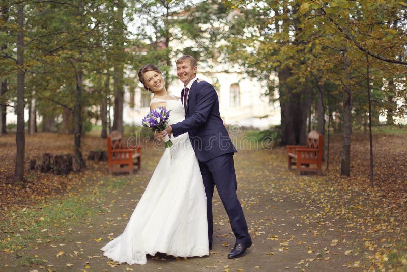 Dance bride and groom in autumn park