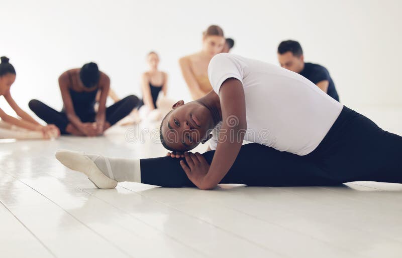 Dance enables you to find yourself. a group of ballerinas warming up before practicing their routine. royalty free stock image