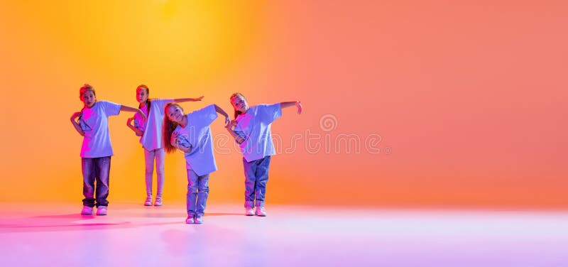 Dance Group of Happy, Active Little Girls in T-shirts and Jeans in ...